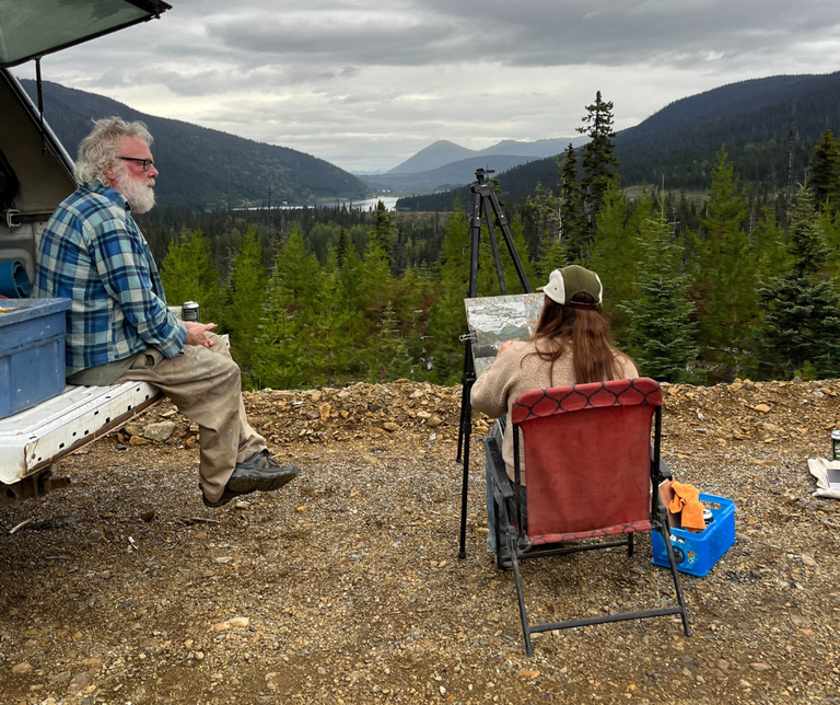Peter Corbett and Natasha Lepine engage in Plein Air painting together at a scenic mountain lookout in Wells, BC.