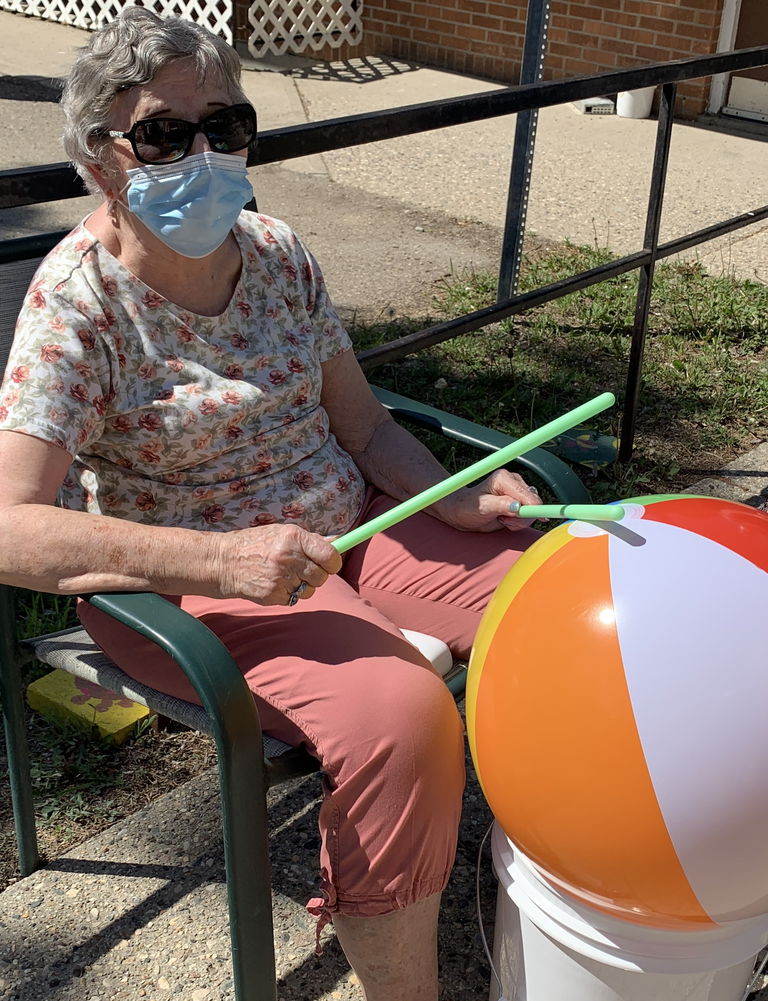 Eden Care Elder of ECC Suites beach ball drumming during the June 1, 2021 Intergenerational Day Celebration. Photo credit: Crystal Massier.