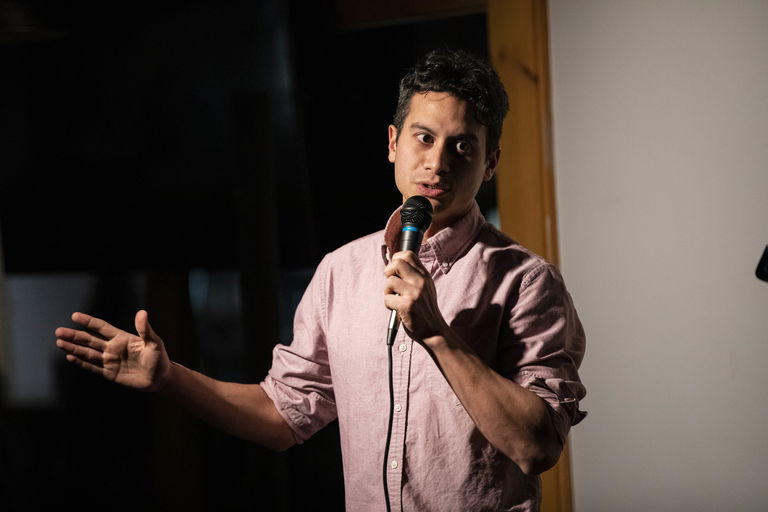 Green performing stand-up on stage. Photo courtesy of the author.