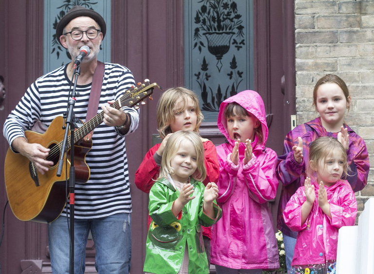 Andy Forgie opens Porchfest 2012 at Glanmore National Historic Site surrounded by 5 young fans.