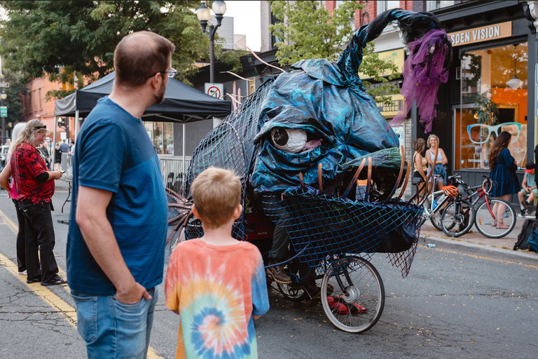 Photo of artist Cesar Cordoba driving his bike powered project Animal Kinetic