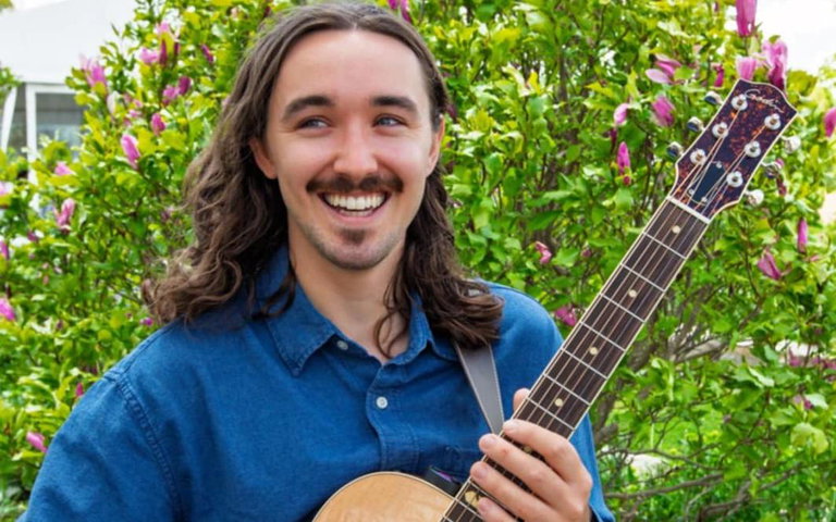 man holding guitar