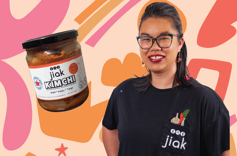 Owner of Jiak, Lo-Anne Chan, on a colourful background beside a jar of kimchi.