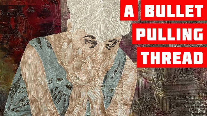 A beautiful and textural art quilt depicts a woman grieving with text in red and white, "A Bullet Pulling Thread."