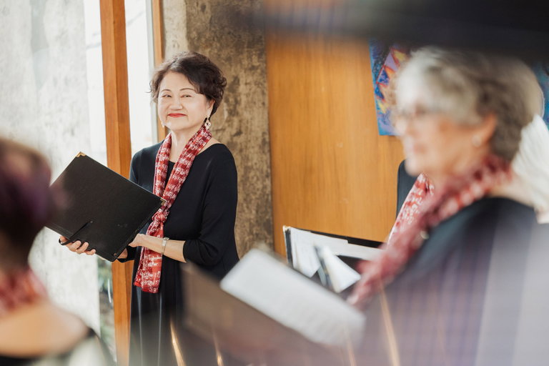 A smiling woman in a choir