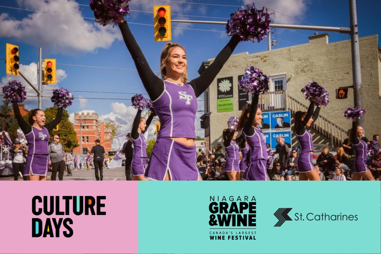 A parade in the downtown St. Catharines core, with a group of cheerleaders dressed in purple cheering.