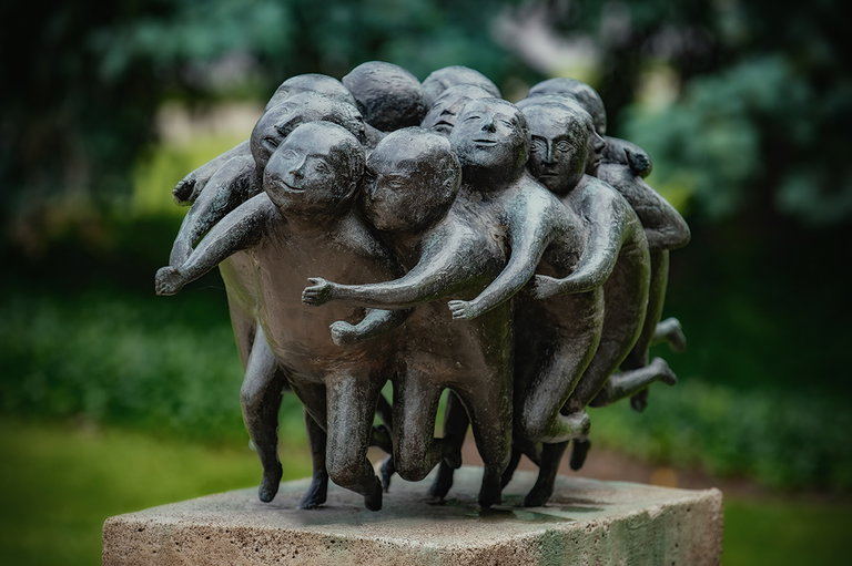 Metal sculpture of group of men running