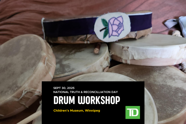 Drums piled up with top drum having a purple ribbon and pink flower
