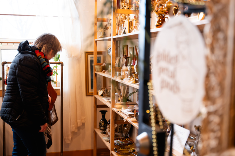 A shopper looks over the items for sale by Golden Petal Goods at 618 ARTlington