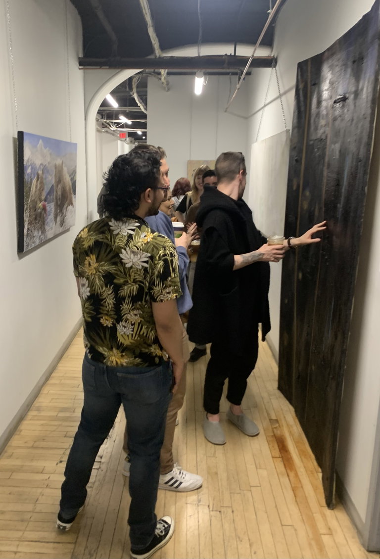 Gallery viewers at studio 6 looking at "Untitled black monlith painting" by Thor Aitkenhead