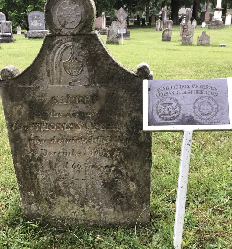 Plaques mark the War of 1812 veteran's graves.