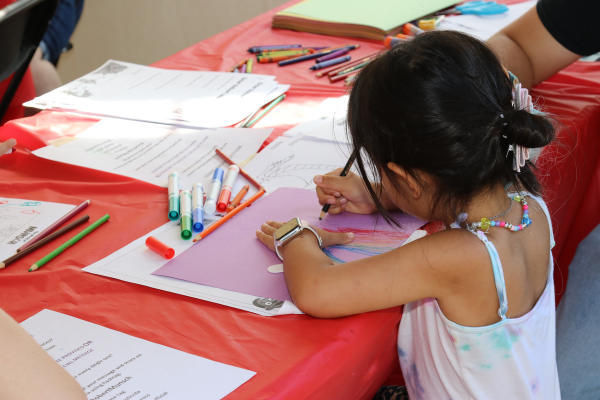 Child colouring a rainbow.