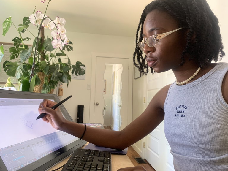 Artist Obi Nwosisi working at digital screen in home studio
