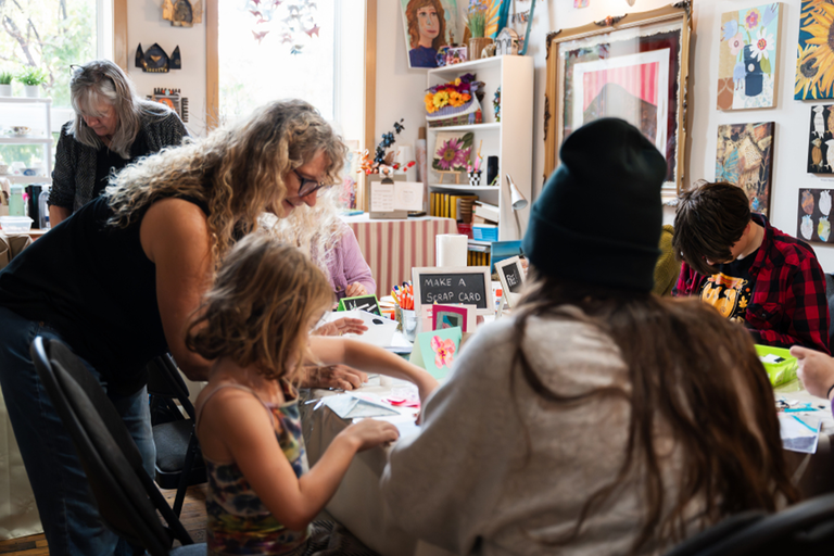 People sitting around a table making crafts