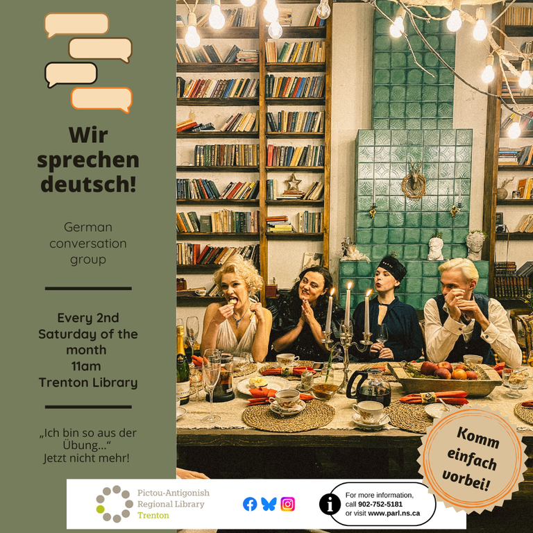 a group of people seated around a dinner table smiling , with candles & food