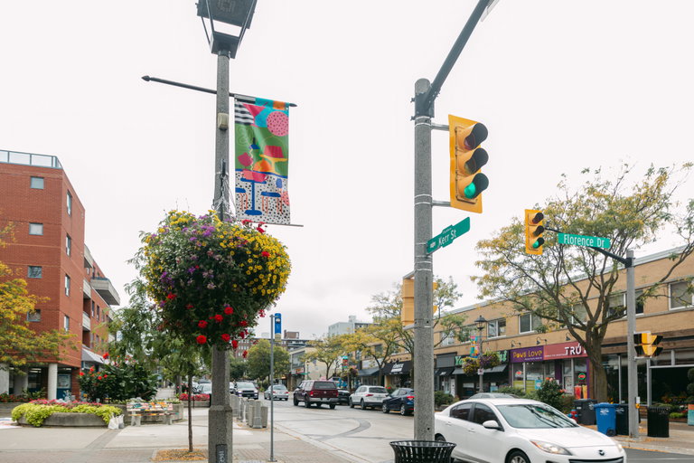 A view of Kerr Street at Florence Drive with the local shops, traffic lights, and pole banners in the background.