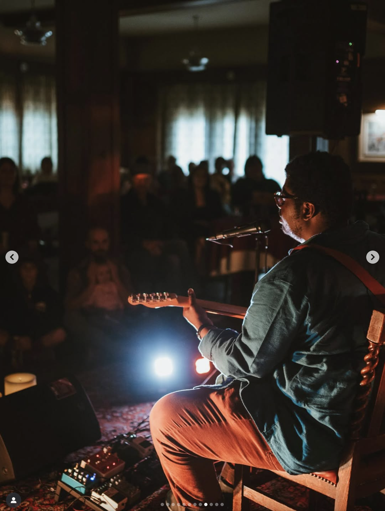 Cedric Noel musician performing with a guitar in front of an audience at Beautiful View