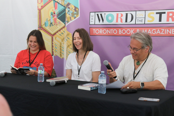 Three speakers take the stage to read stories, and share experiences for the audience.