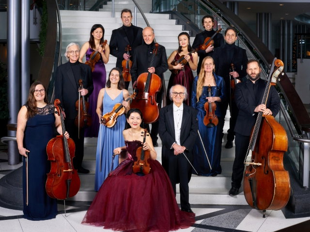Formal portrait photo of a string orchestra