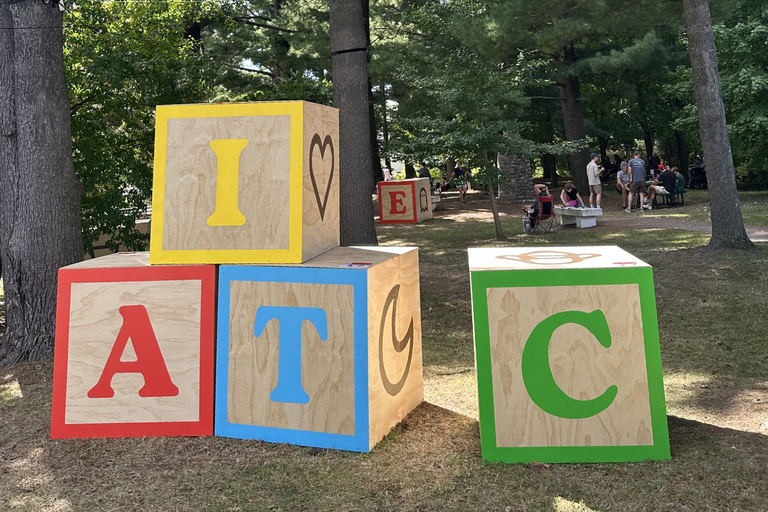Wooden children's letter blocks at a large scale in a park
