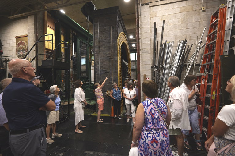 Tour attendees looking at backstage items.