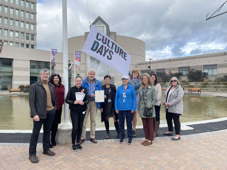 City employees and partners with Culture Days flag at City Hall