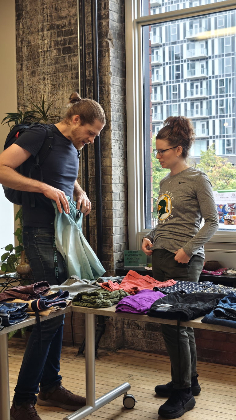 community members checking out clothing items from the swap