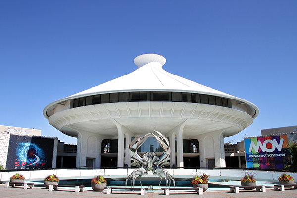 The view of the Museum of Vancouver building with crab statue/fountain in front.