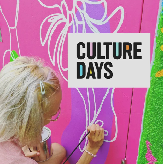 Artist Monica Loney painting a mural