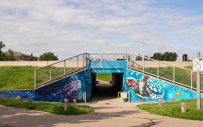 Entrance to the Father Leonard von Tighem School in Lethbridge, Alberta. Large imagery of a sea turtle and a jellyfish flank the entrance.