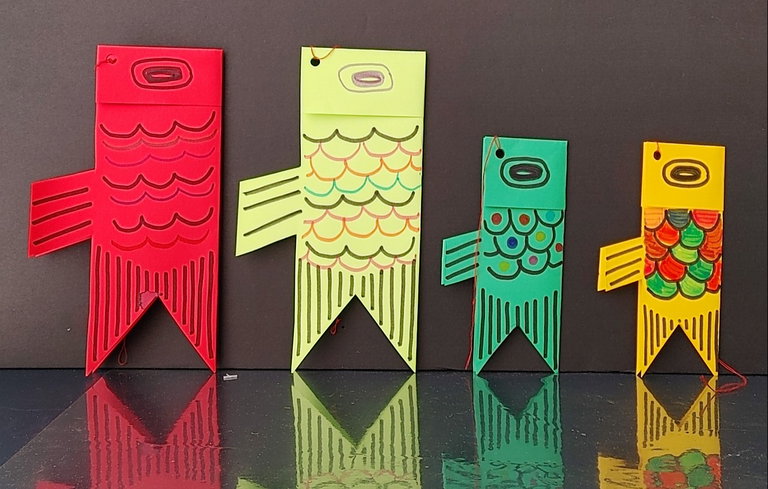 The largest fish windsock represents the father and is followed by a slightly smaller one that represents the mother.  The smaller ones represent the children in the family.