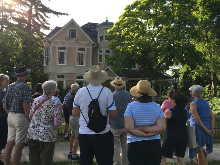 Tour group looking at a house.
