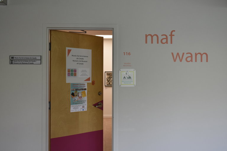 An image of the Women's Art Museum front door slightly ajar.