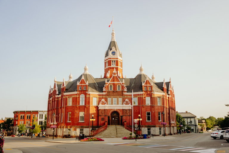 An image of City Hall in Stratford, Ontario, a red brick Queen Anne Revival style structure completed in 1900.