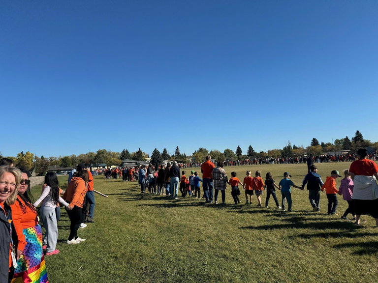 People holding hands in two large circles