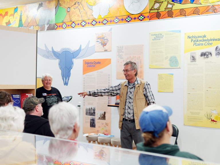Dr. Leo Omani talks in front of an audience at the Historical Museum